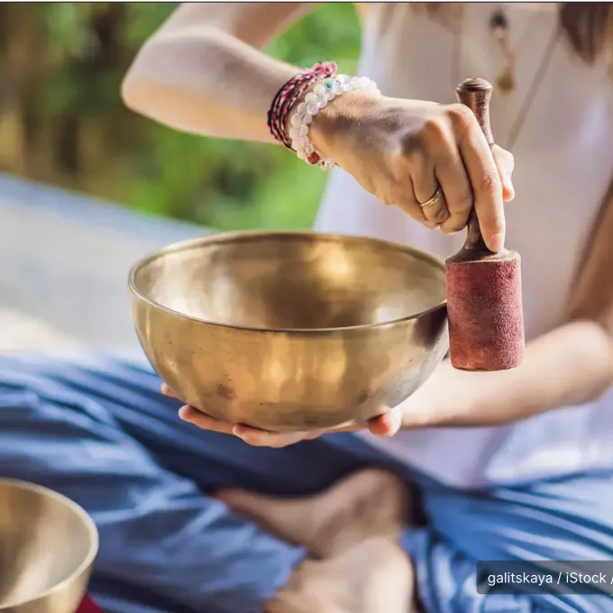 "Person playing a singing bowl"